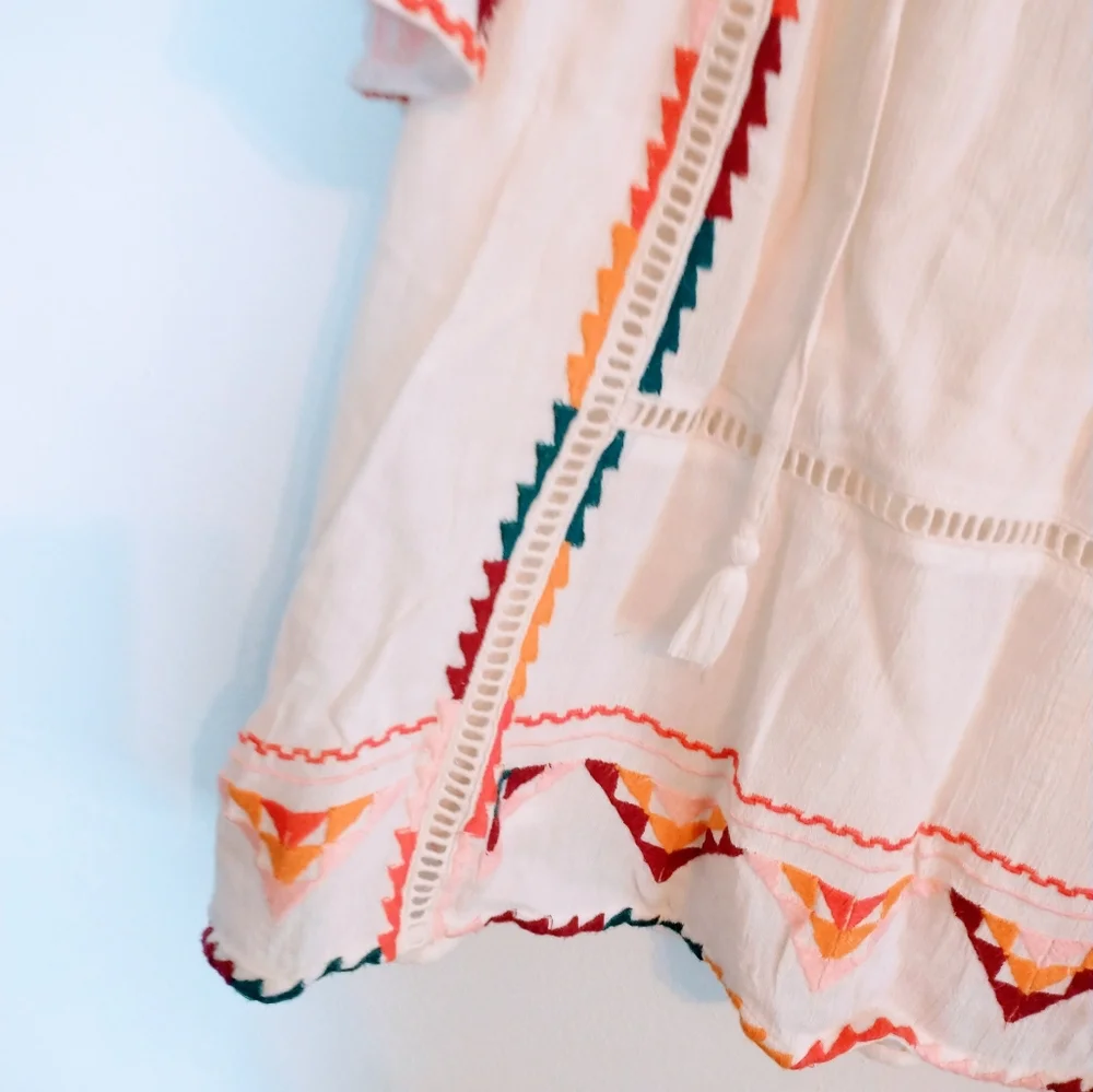 Tularosa Ingrid embroidered boho top from Revolve.  Has tassels in the front and